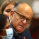 Rudy Giuliani, looking puzzled by someone wearing a mask